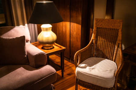 Lamp on a night table next to a bedの写真素材