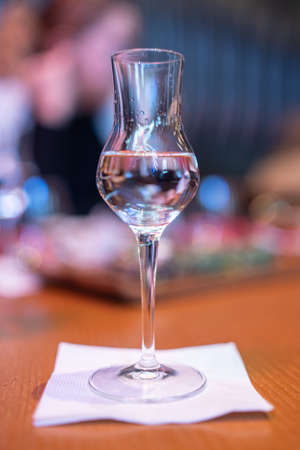 Shot glasses of vodka on a wooden table, addiction to alcohol.の写真素材