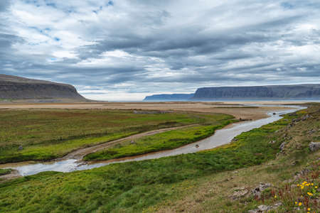 Panoramic Image of Gorgeous Colorful sunset over the mountain landscapes and waterfalls. Iceland.の写真素材