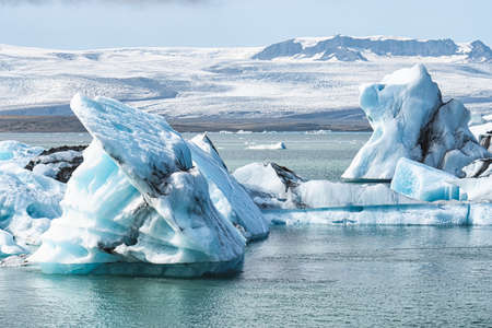 The beautiful cold winter landscape of the Jokulsarlon glacier lagoon in Iceland, in the winter with snow-capped mountain as a background.の写真素材