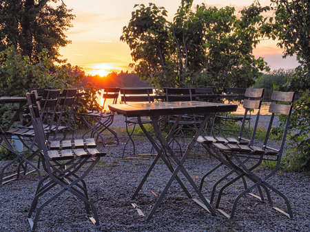 Image of Cafe table near the lake at evening, focus on tableの写真素材