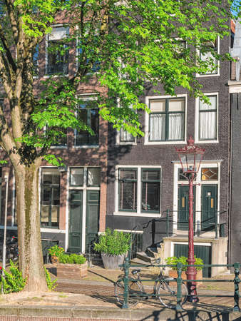 Image of Amsterdam canals and typical houses with clear summer skyの写真素材