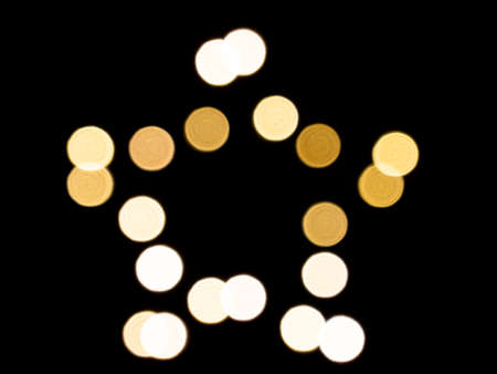 Defocused image of star shaped light on the black backgroundの写真素材