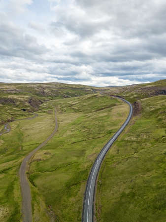 car driving on beautiful road, travel background, aerial scenic landscape from Icelandの写真素材
