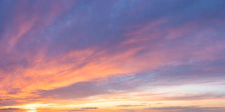 Vibrant color panoramic sun rise and sun set sky with cloud on a cloudy day.の写真素材