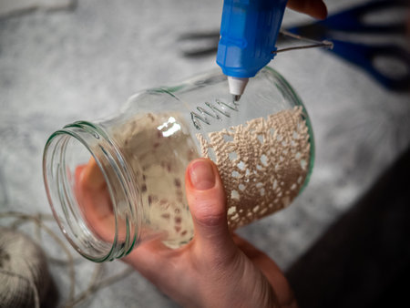 Cozy handmade holiday home decor, glass jars decorated white ribbon.の写真素材