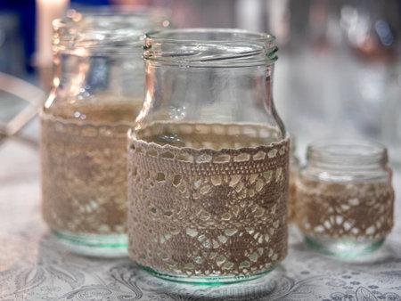 Cozy handmade holiday home decor, glass jars decorated white ribbon.の写真素材