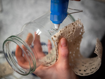 Cozy handmade holiday home decor, glass jars decorated white ribbon.の写真素材