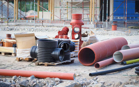 Various plastic pipes and other materials on the construction siteの写真素材