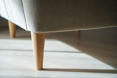 Wooden chair legs on the laminated wooden floorの写真素材