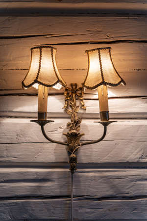 Old vintage bronze double lamp on the white wooden wallの写真素材