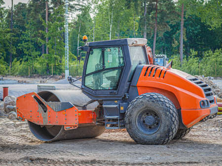 Road construction. Large rolling machinery paving a road to a distant cityの写真素材