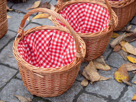 Wicker basket with red napkin on the floor, closeupの写真素材