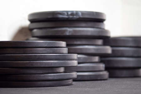 Image of black gym weigth plates on the floorの写真素材
