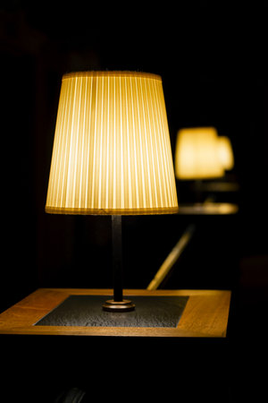 Row of the table lamps at a low light atmospheric restaurant. Selected focus and bokehの写真素材