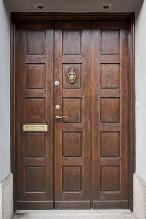 Image of Wooden vintage entrance door with handle knocker and handleの写真素材