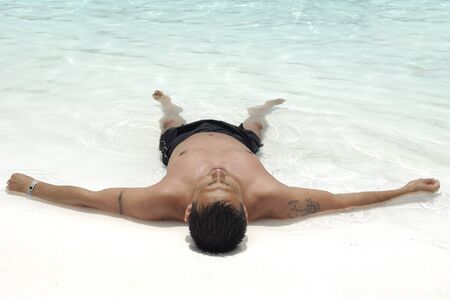 A man is relaxing in swimming poolの写真素材