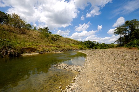 River and green nature with white clouds. Dominican Republic.の写真素材