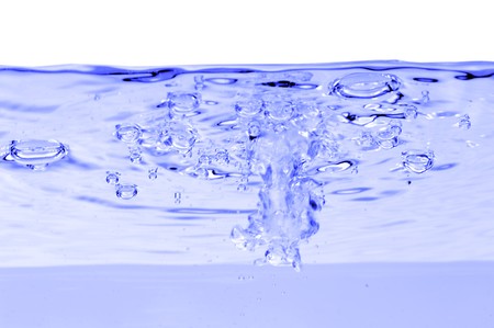 Blue water with air bubbles in the water line. 