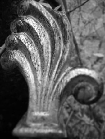 A black and white infrared/ultraviolet macro of an art deco finial on a wrought iron fence post.の写真素材
