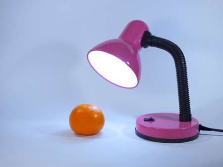 Orange and a desk lamp.の写真素材