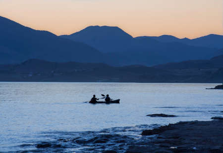 Summer sunset over the warm, southern sea. Water sport. Kayak. Outdoor activity. Healthy lifestyle.