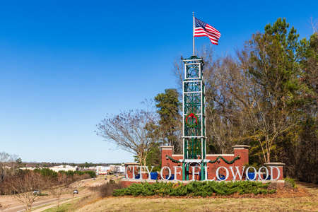 Flowood, MS / USA: City of Flowood welcome sign with American Flag waving in the wind, and some holiday decorationsのeditorial素材