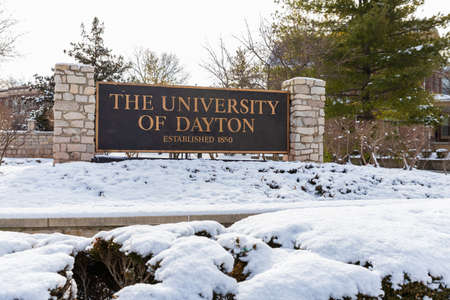 Dayton, OH, USA: University of Dayton sign, with fresh winter snow on the ground.のeditorial素材