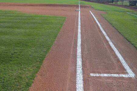 Baseball Field 1st base coaches box with fresh grass and chalk lines