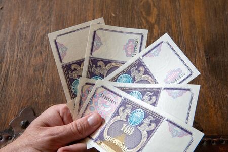 Hand Holding Uzbekistani money, known as So'm.