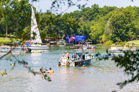 Mooresville, NC, USA - July 4, 2020: Boats flying Trump 2020 flags for President Donald Trump on Lake Norman near the Trump National Golf Club Charlotteのeditorial素材