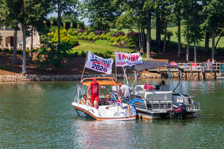 Mooresville, NC, USA - July 4, 2020: Boats flying Trump 2020 flags for President Donald Trump on Lake Norman near the Trump National Golf Club Charlotteのeditorial素材