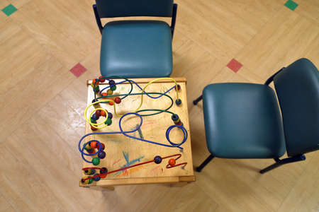Chirldren's clinic waiting room of a medical office with toys and chairs, looking straight down