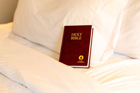 Memphis, TN, USA / September 3, 2020: Gideons Bible on bed in hotel room.のeditorial素材