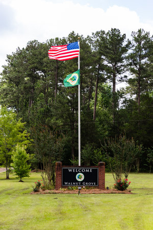 Walnut Grove, MS - June 9, 2021: Welcome to Walnut Grove sign and flagsのeditorial素材