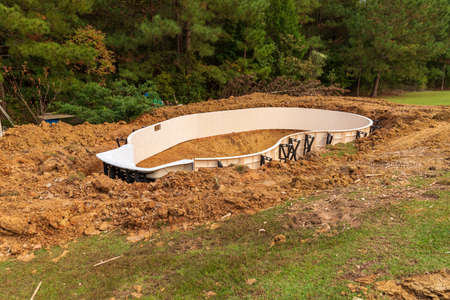 New swimming pool being installed in a back yard