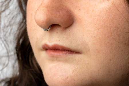 Close up of young woman with nose ring.の写真素材