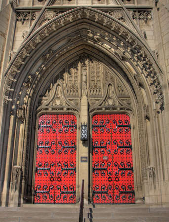 Big red doors for a limestone gothic church
