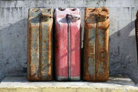 three rusty fuel tanks in harbourの写真素材