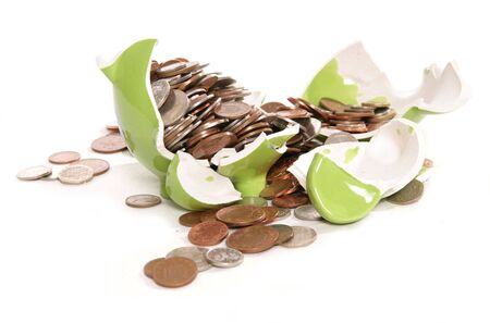 smashed piggy bank moneybox with British currency coins