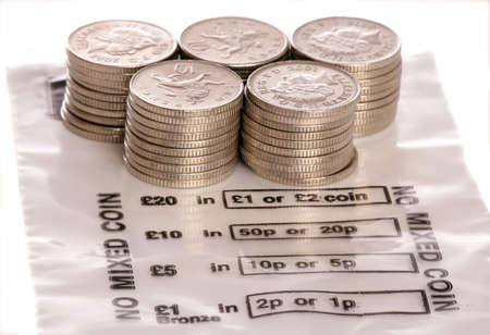 Money bag with sterling ten pence coins studio