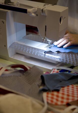 Person on sewing machine making Jubilee bunting