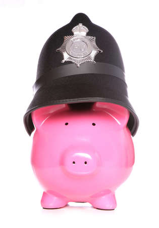 piggy bank wearing police hat on white backgroundの写真素材