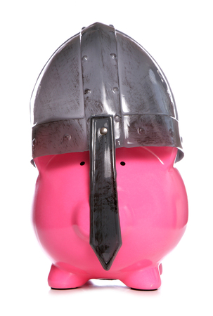 Piggy bank wearing a viking helmet cutoutの写真素材