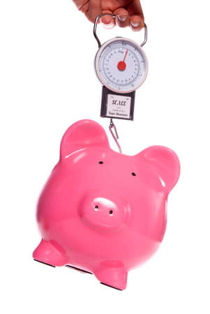 Piggy bank on weighing scales studio cutoutの写真素材