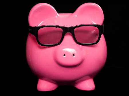 Piggy bank wearing 3D glasses studio cutoutの写真素材