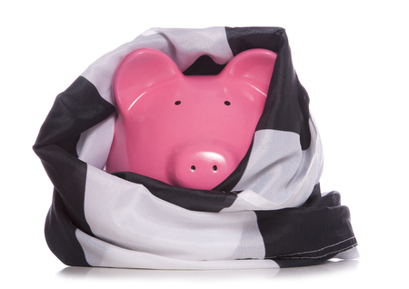 piggy bank wrapped in checkered flag studio cutoutの写真素材