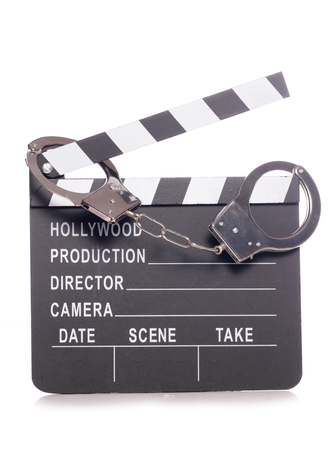 film clapper with handcuffs studio cutoutの写真素材