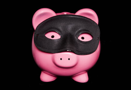 piggy bank wearing black masquerade mask cutoutの写真素材