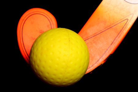 Hockey ball and stick on black backgroundの写真素材